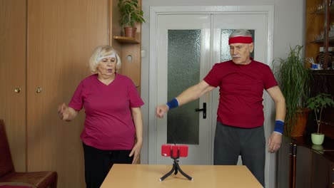 Mature-couple-man-and-woman-fitness-trainer-coach-records-video-online-workout-exercises-course