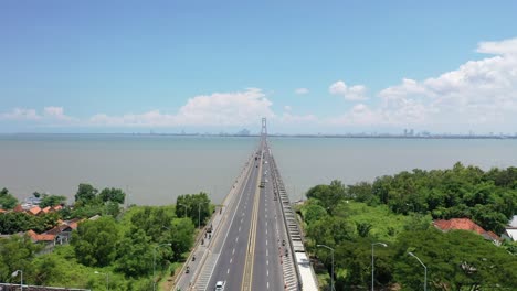 Beautiful-drone-heading-to-Surabaya-over-the-longest-bridge-in-Indonesia,-Suramadu-Bridge