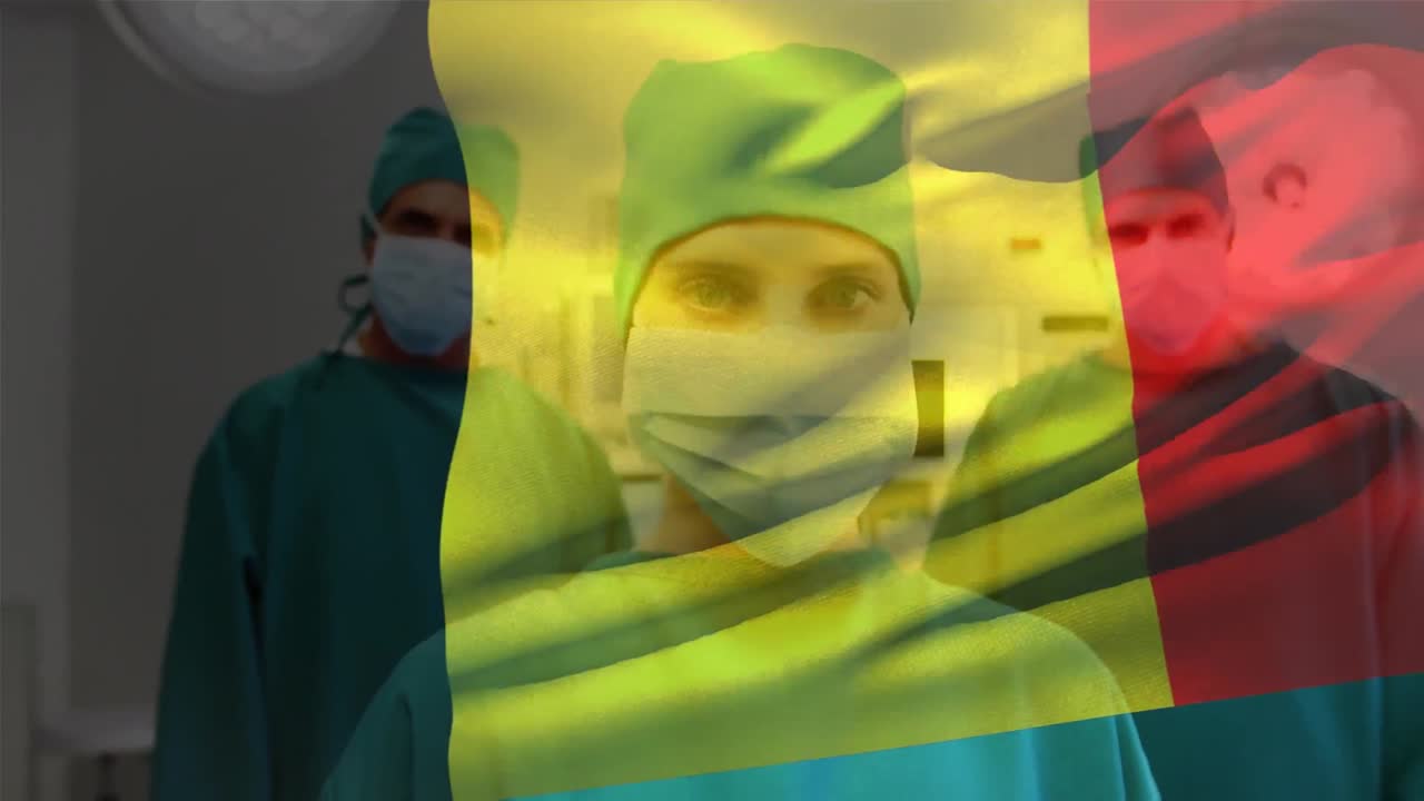 Animace vlající belgické vlajky s týmem různorodých chirurgů stojících v nemocnici.