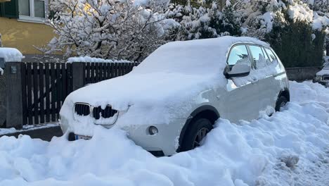 snowstorm covered unrecognizable jeep car with heavy white snow, wide shot