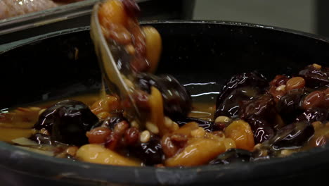 mixing dried fruits in a bowl