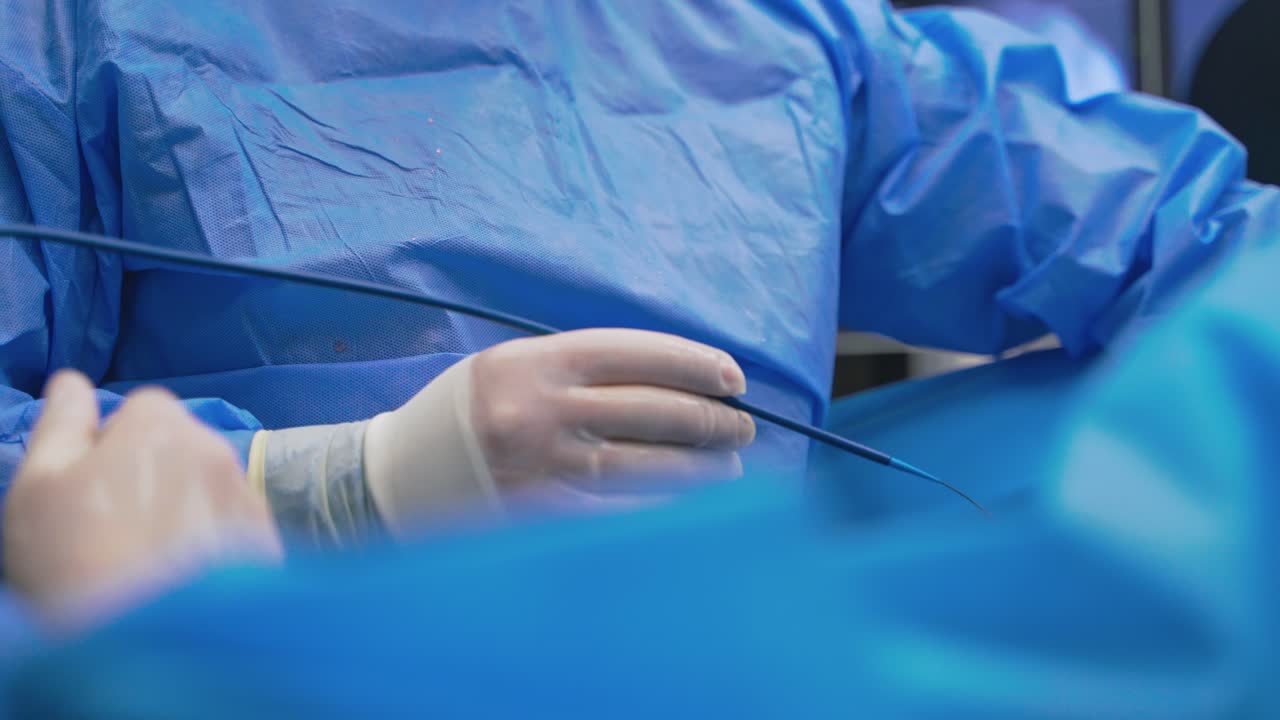 Endoscopy in clinic. Surgeon and nurse during operation. Medical specialists perform a surgery using new equipment in operating room. Close-up.