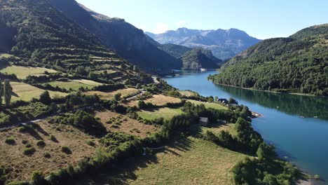 Lake-Embalse-de-Bubal-at-Valle-de-Tena-Valley-in-Huesca,-Aragon,-Spanish-Pyrenees,-Spain---Aerial-Drone-View-of-the-Green-Valley-and-Water-Reservoir