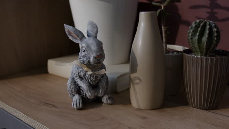 decorative rabbit and plants on a shelf