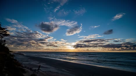 beach time lapse. clouds and blue sky over sea and sandy beach.