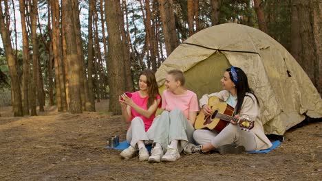 three friends camping and having fun