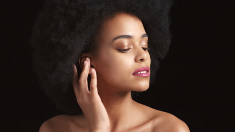 Black-woman,-afro-and-glowing-skincare-on-studio