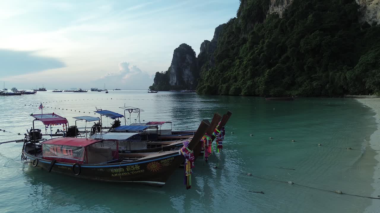 Calm beach Phi Phi Islands Thailand with longtail traditional thai boats moored