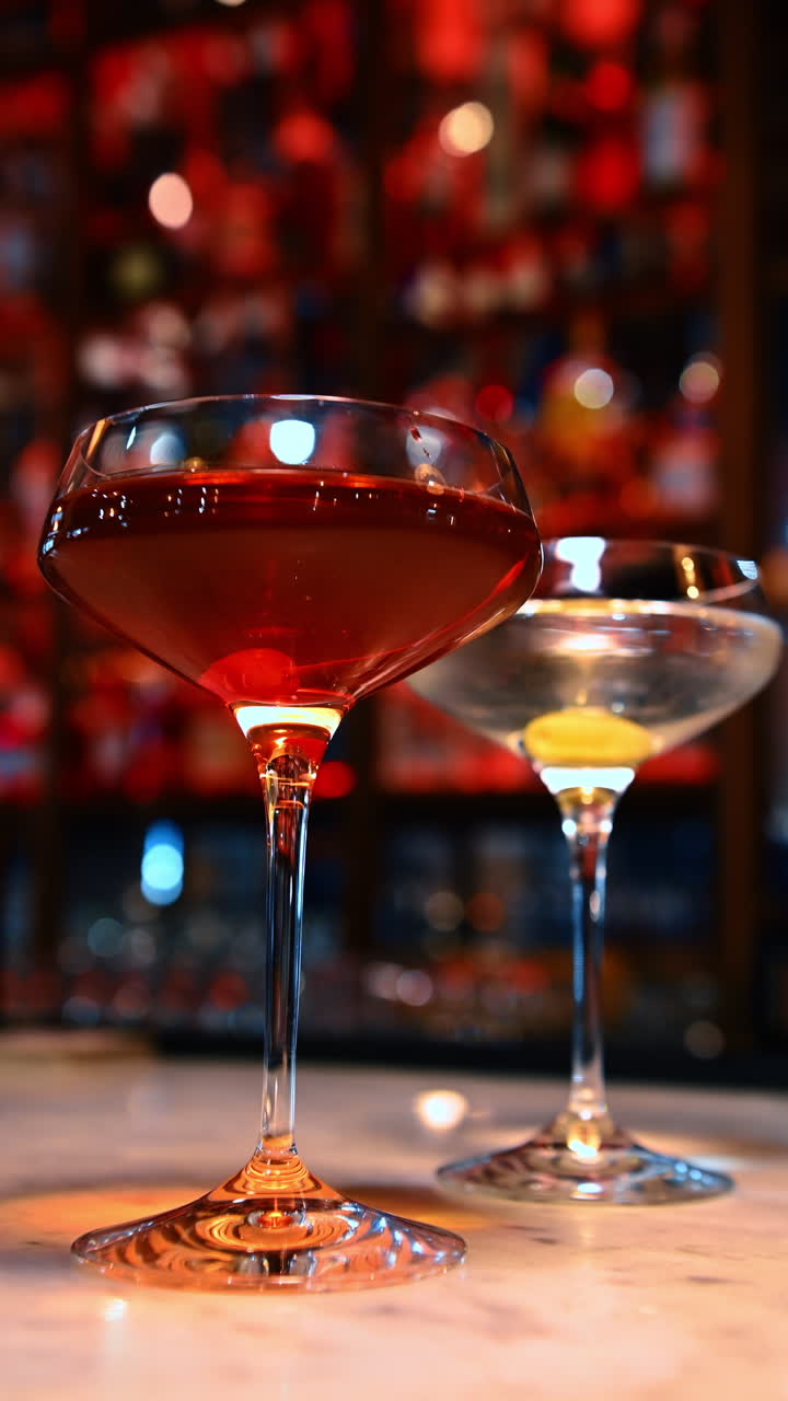 Two cocktails on marble. Two elegant cocktails rest on a marble counter ...