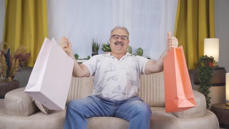 Old-man-looking-at-camera-with-shopping-bags.