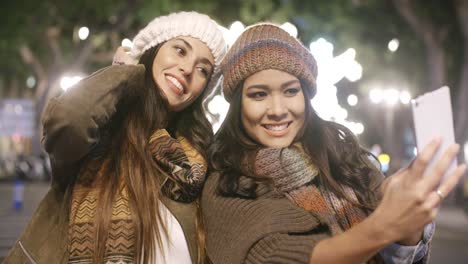 two vivacious women taking a selfie