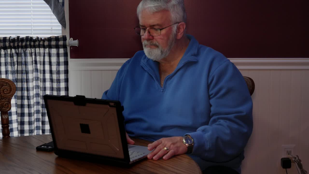 Senior Citizen Happy Using a Computer and Technology to do Daily Activities
