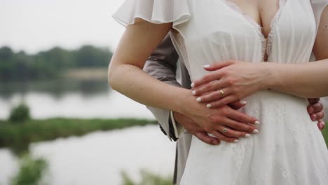 wedding couple embracing by the river during a photo video session