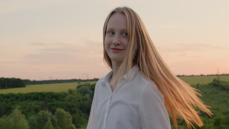 portrait of a happy teenage girl, turns around and looks at the camera