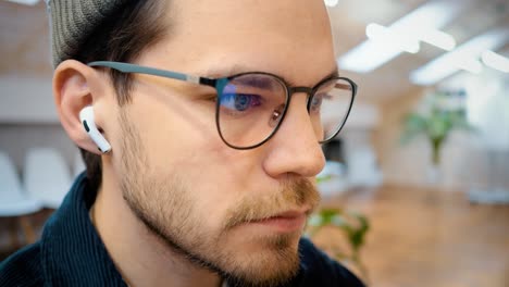 man with glasses. close-up. long and hard work behind the monitor.