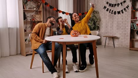 happy family taking selfies during halloween celebration