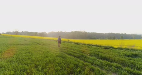 Agriculture-Male-Farmer-Walking-On-Track-Over-Agricultural-Field-While-Using-Digital-Tablet-23