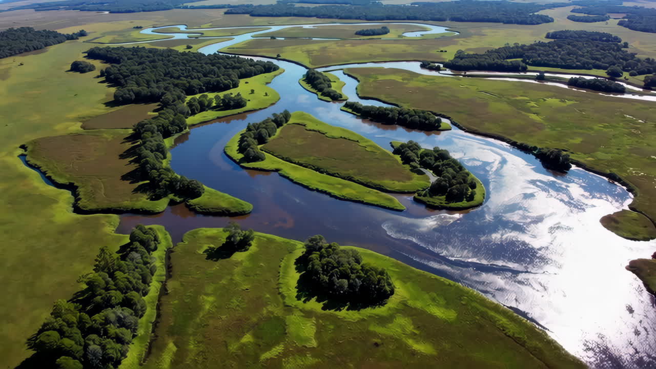 Aerial View of a Winding River Through a Lush Green Landscape