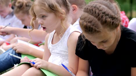 group of cheerful children learning outdoors at school after quarantine lockdown