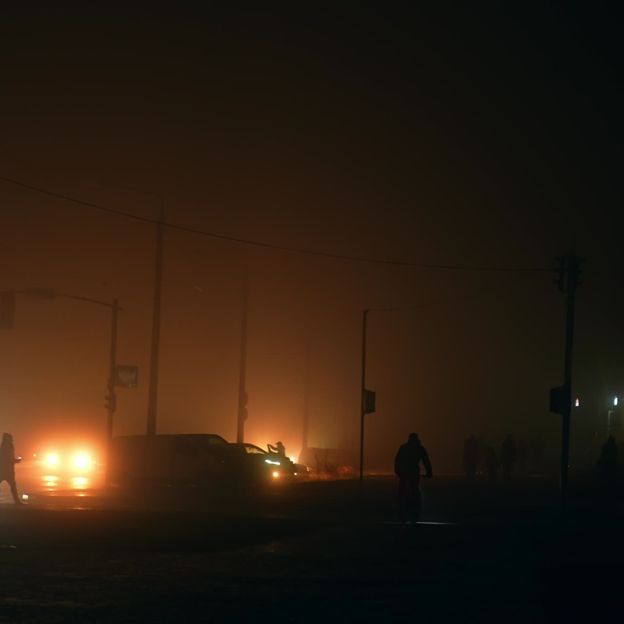 Man riding a bicycle at night by the dark street during power outage. Ukrainian energy crisis from war