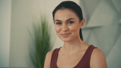 portrait of young pretty smiling athlete woman at home, looking at camera