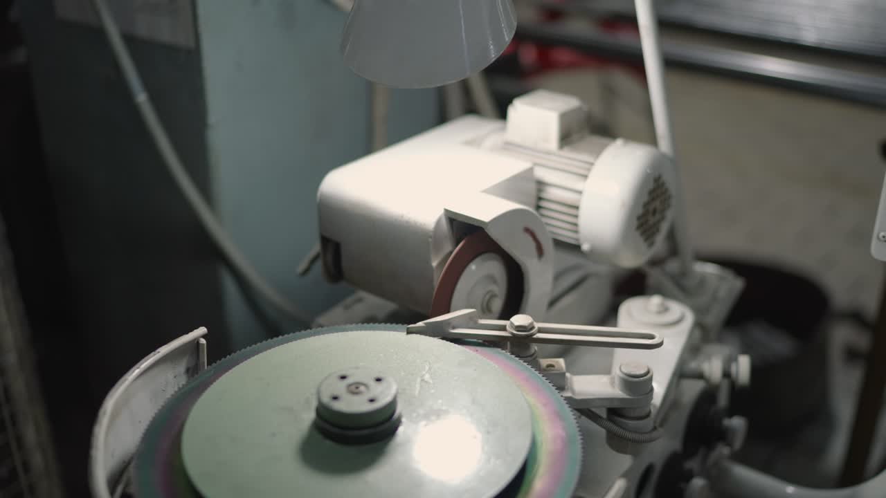 Close-up of Industrial Blade Sharpening Machine in Textile Factory