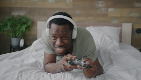 hombre jugando videojuegos en la cama
