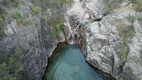 aerial ascending view over waterfall portela do homem