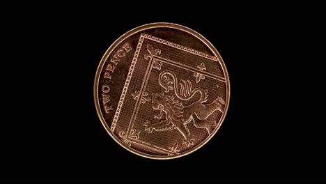 United Kingdom 2 pence 2015 reverse showing Royal Shield segment, macro loop on black background