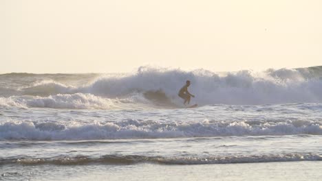 Surfer-Falling-Off-His-Surfboard