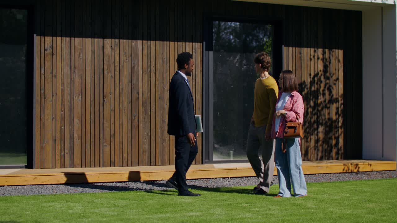 Real Estate Agent Showing Modern House to Couple