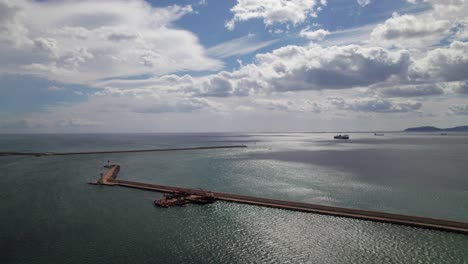 aerial view of a harbor with ships and a breakwater