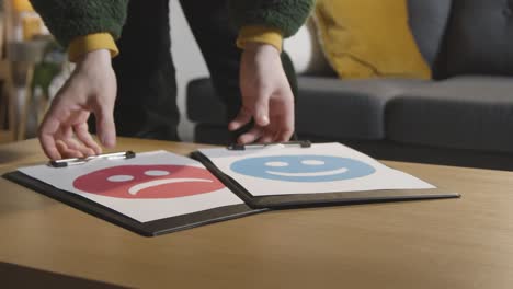 psicólogo educativo recogiendo imágenes para evaluar la respuesta emocional en la mesa en casa para un niño diagnosticado con tea