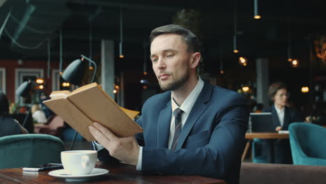 businessman reading in a cafe