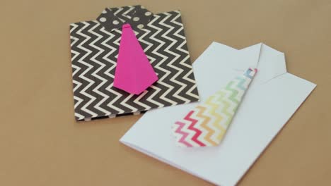 Brightly-colored-shirt-shaped-gift-cards-on-neutral-background,-concept-for-creative-gifting