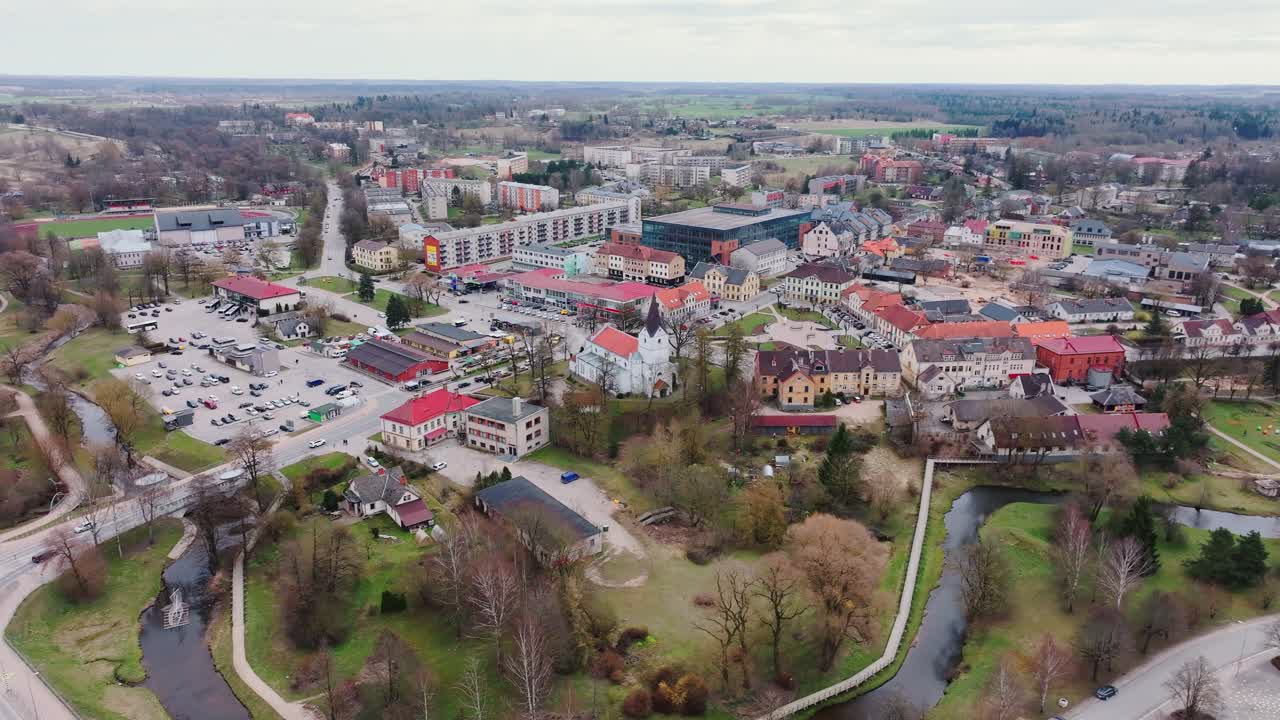 Saldus cityscape unfolds in drone orbit around church, market and river