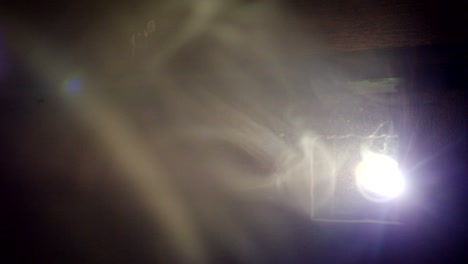 dark cinema hall with light smoke and projector