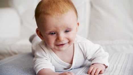 Happy-joyful-red-haired-baby-trying-to-crawl