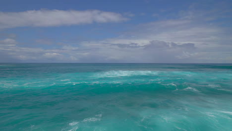 flying over the pacific ocean on the north shore of oahu hawaii