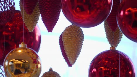 christmas and new year decoration. christmas big red balls on  background of luminous lanterns and gold garlands. holiday background. blinking garland. red baubles with lights twinkling close up.