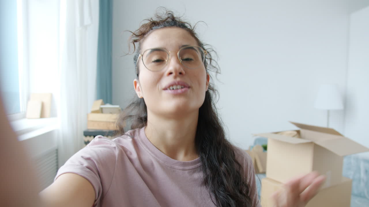 Woman taking a selfie in a new apartment during a move