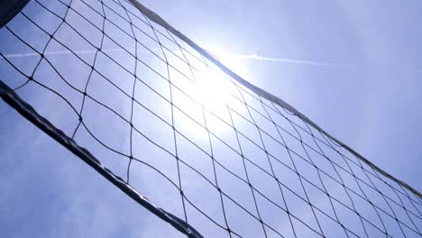 volleyball net on the ground court under the heat of the sun. close up shot. beautiful footage on the beach.
