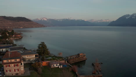 Flying-over-lakeside-houses-towards-a-vast-and-beautiful-lake