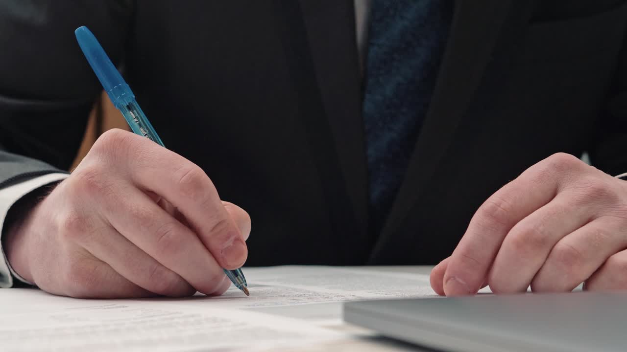 Businessman taking notes or signing contract, pen and document, man in formal jacket. Close up hand