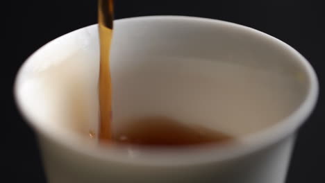 pouring tea into a cup