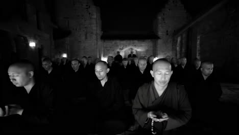 monks meditating in a dark temple