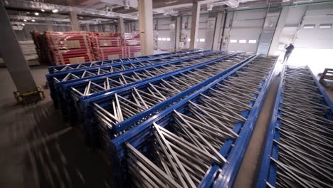 big and modern warehouse under construction, featuring metal shelving and other industrial equipment.