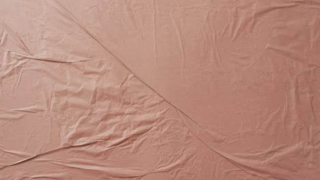 video of close up of beige creased fabric with copy space