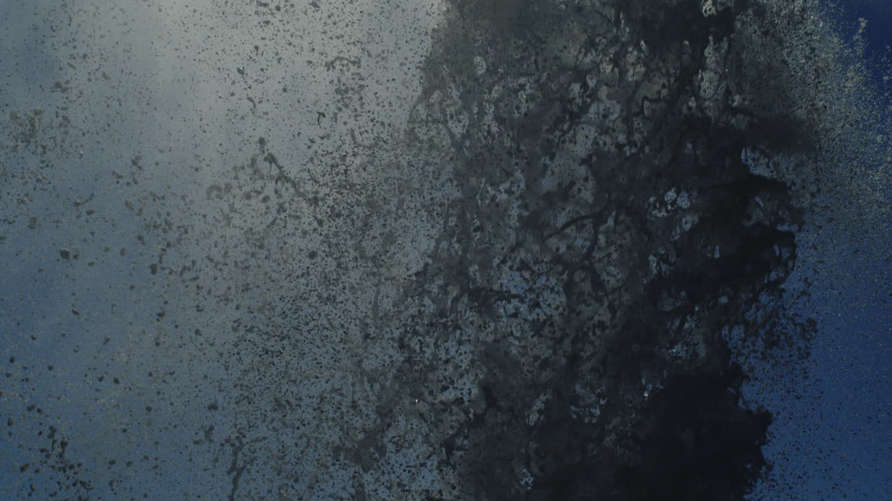 Ocean plume shoots into the sky with water vapor and spray particles rising upward