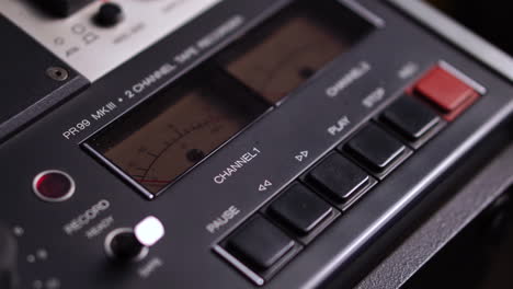 audio vu meter levels on professional reel-to-reel magnetophone recorder player, close up